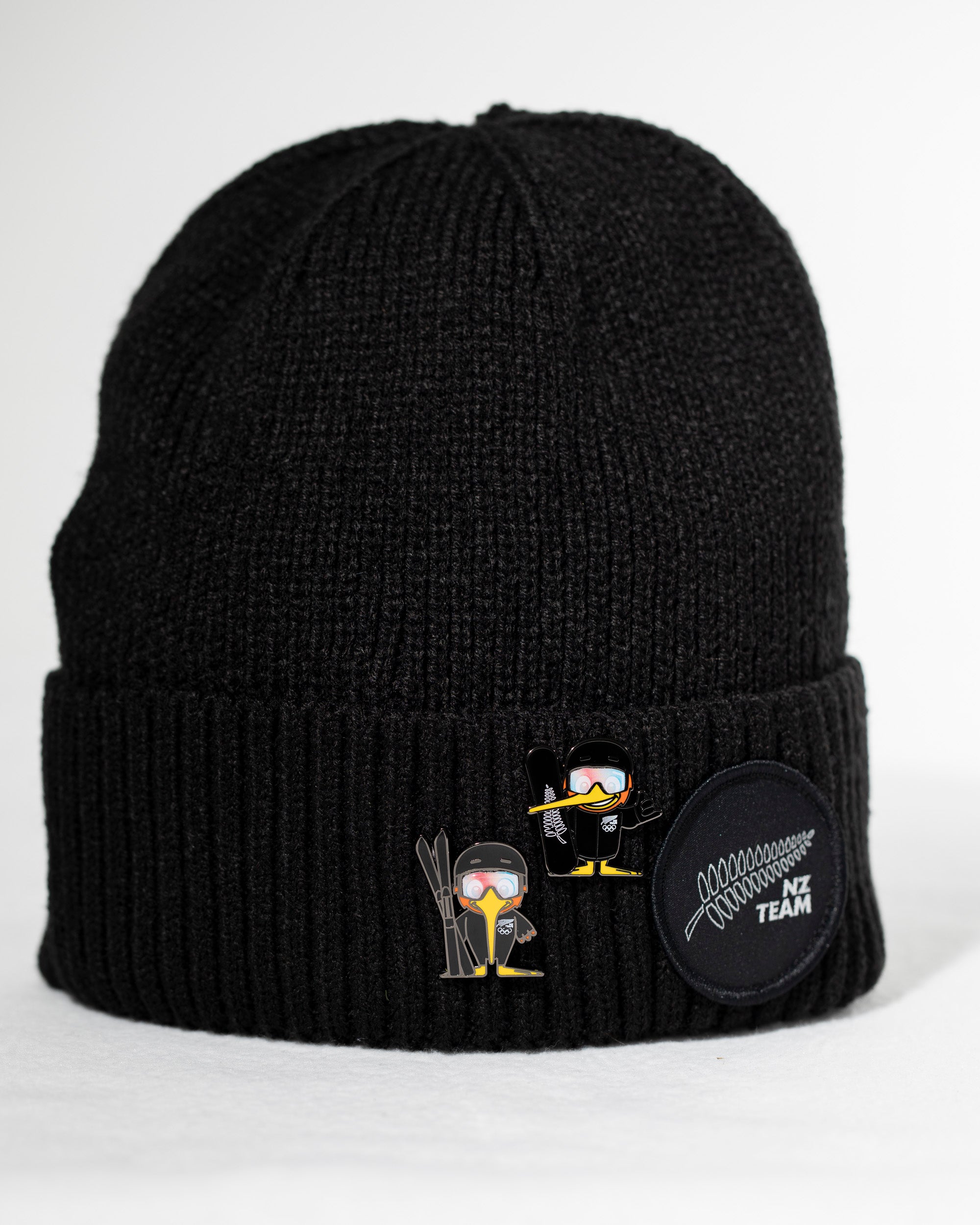 Black beanie with embroidered designs on a white background
