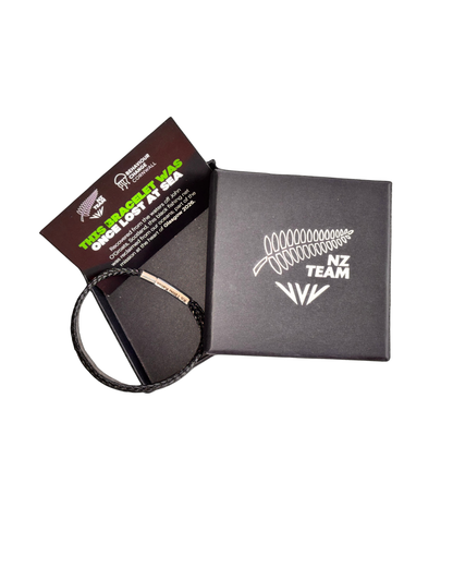 Black woven NZ Team bracelet shown with packaging