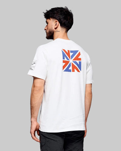 Man wearing a white t-shirt with a Union Jack design on the back against a gray background