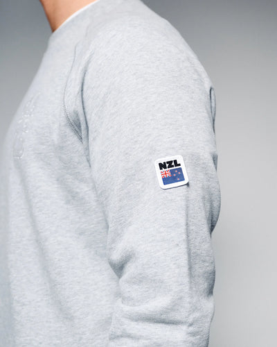 Gray sweatshirt with a NZL flag patch on a gray background
