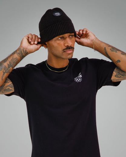 Man wearing a black t-shirt with NZ Team logo on front left side